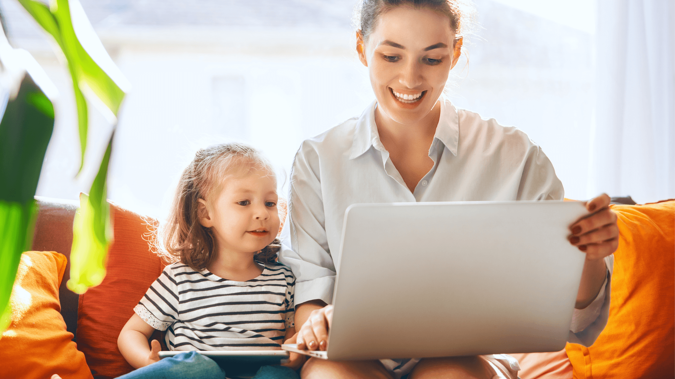 women show laptop to girl child