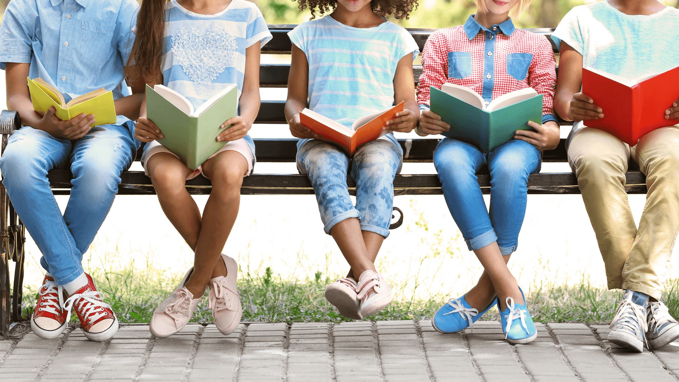 Kids sitting together and studying in the park