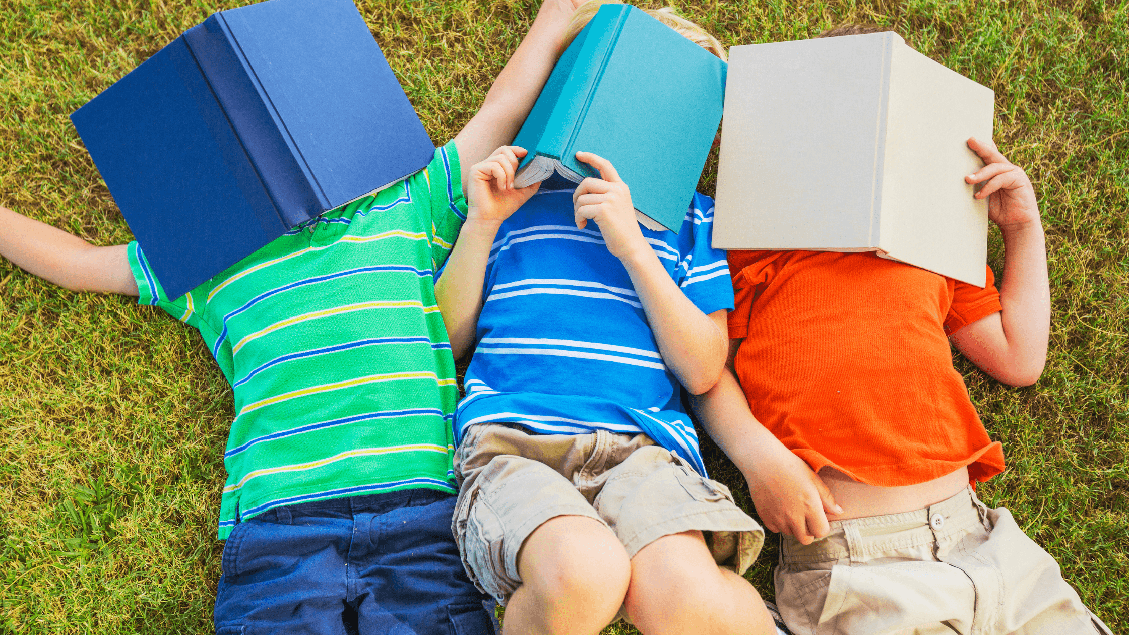 Kids lying Down on Grass  Putting book on their face