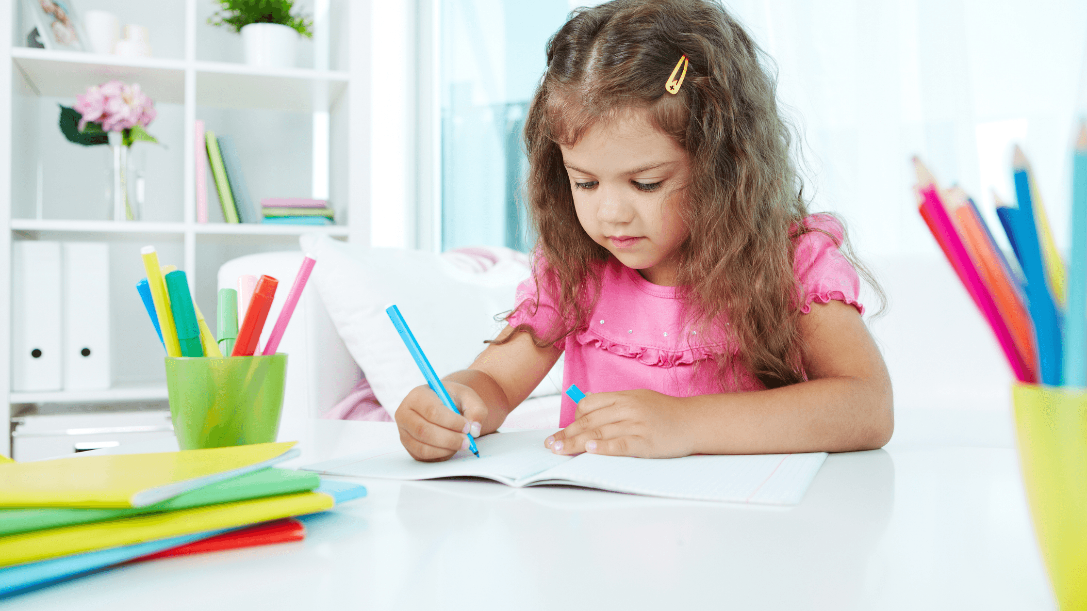 a girl writting with pencil