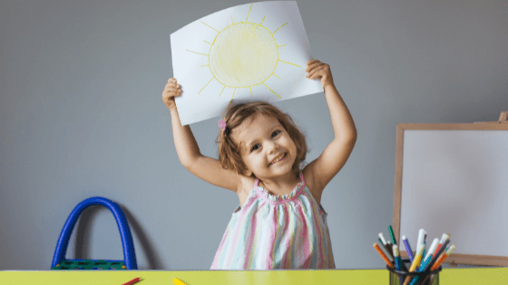 a child showing her painting