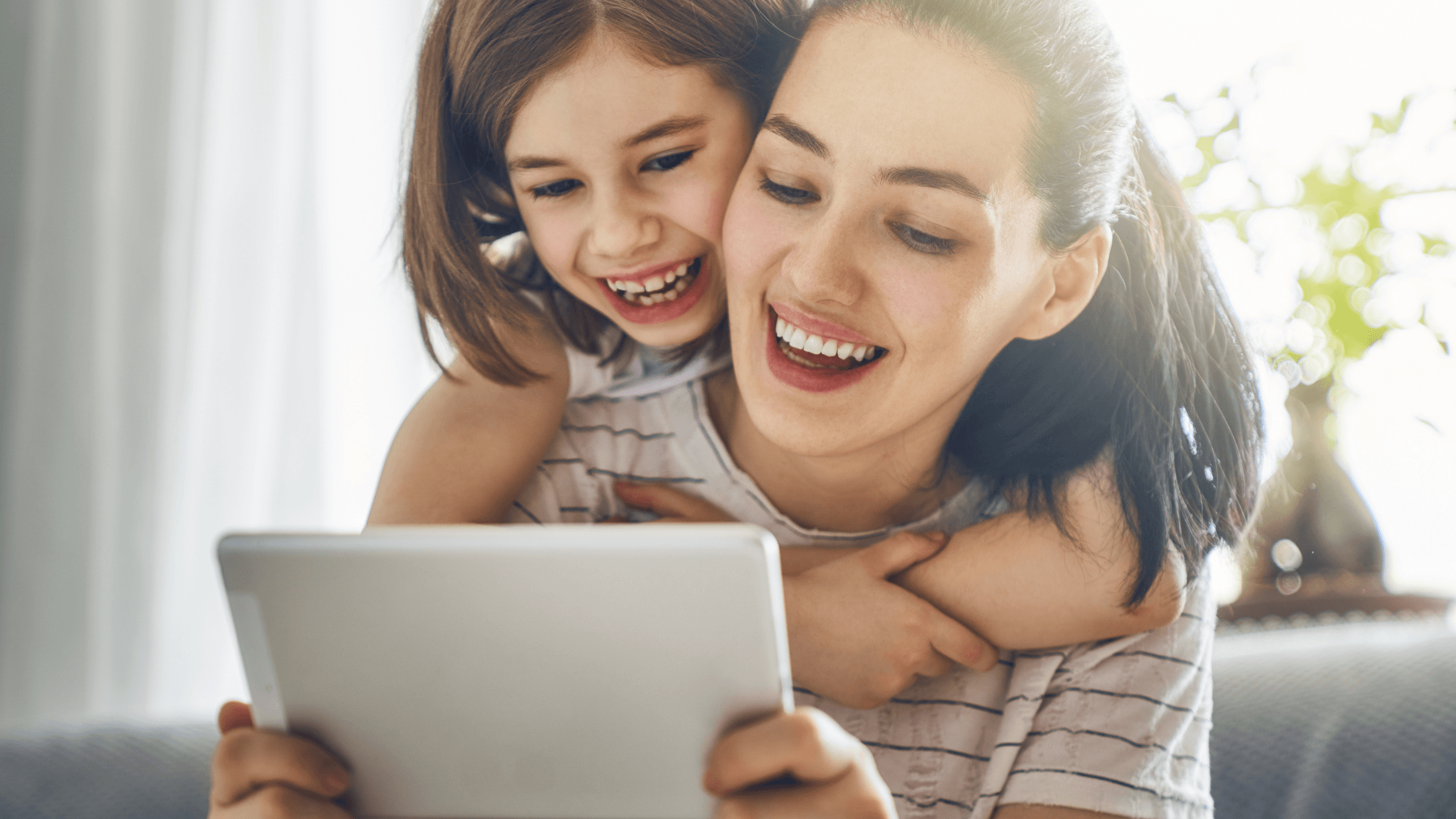 a women and girl child smiling 