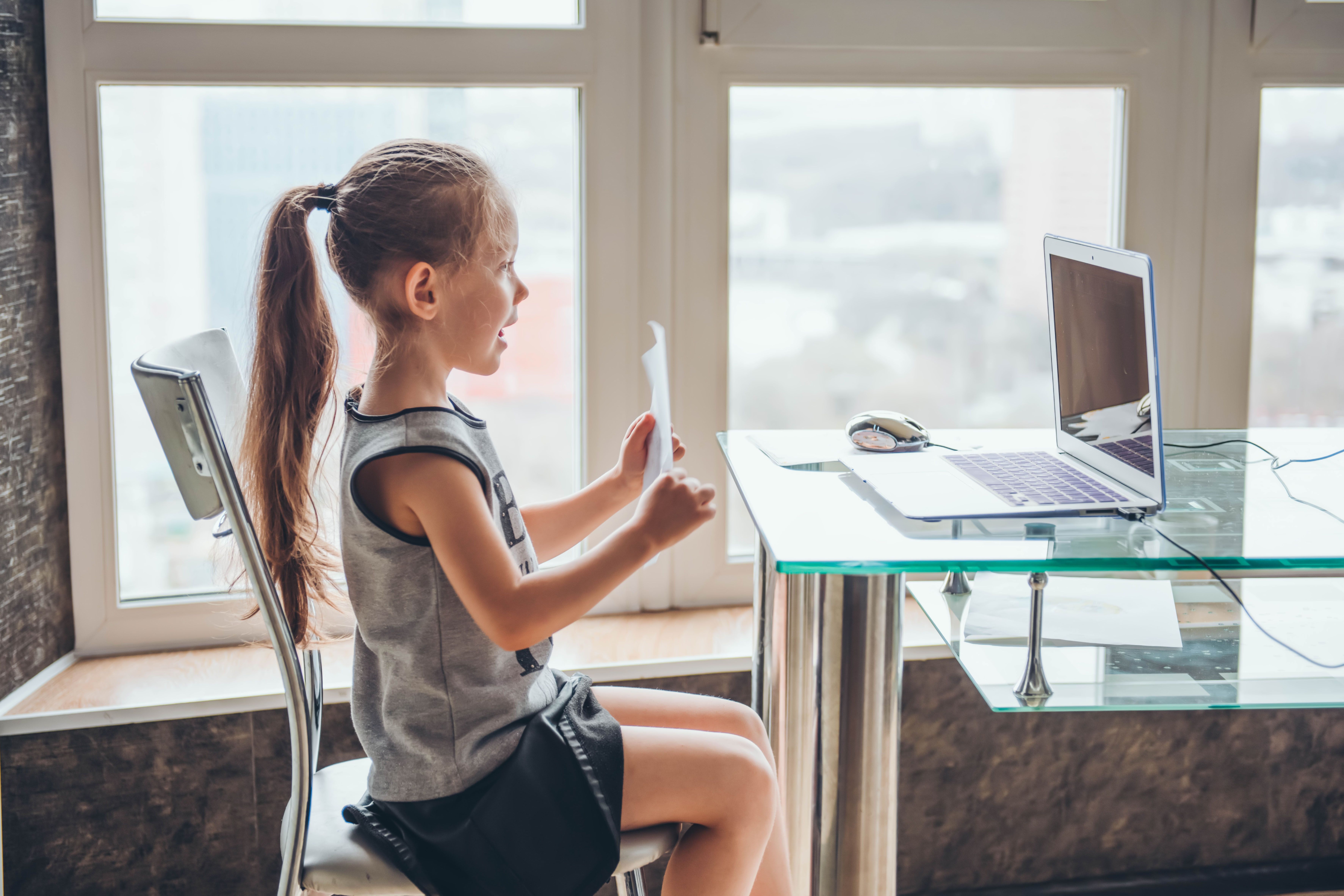Kid showing homework in online class 